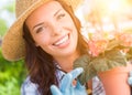 Young Adult Woman Wearing Hat and Gloves Gardening Outdoors