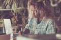 Young adult woman work at the desktop in smart working activity - hipster young lady businesswoman with laptop computer working Royalty Free Stock Photo