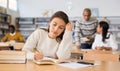 Young adult woman studying in public library Royalty Free Stock Photo