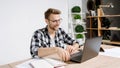 Young adult worker making video conference in office