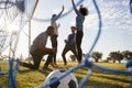 Young adults cheering a scored goal at football game Royalty Free Stock Photo