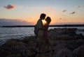 young adults in love, a teenager boy and girl hugging at sunset on the coast, in anticipation of a kiss