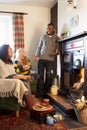 Young adults making toast on open fire Royalty Free Stock Photo