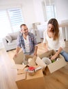 Young adults unpacking boxes Royalty Free Stock Photo