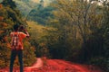 A young adventurer with a backpack standing and take photo scenery  .concept of living and adventure on a single holiday in the ju Royalty Free Stock Photo