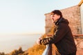 young adventurer resting on a railing on top of a hermitage, watching a beautiful cloudless sunset in the sky in Lleida Royalty Free Stock Photo