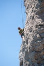Young adventurous person rock climbing