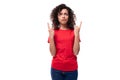 young advertiser woman dressed in a red basic t-shirt on a white background with copy space