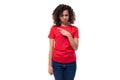 young advertiser woman dressed in a red basic t-shirt on a white background with copy space