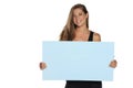 A young advertizing smiling woman holds empty board