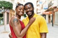 Young afircan american couple smiling happy and hugging at the city