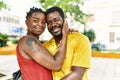 Young afircan american couple smiling happy and hugging at the city