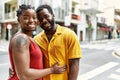 Young afircan american couple smiling happy and hugging at the city