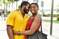 Young afircan american couple smiling happy and hugging at the city