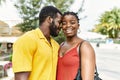 Young afircan american couple smiling happy and hugging at the city