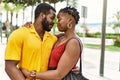 Young afircan american couple smiling happy and hugging at the city