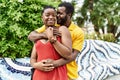 Young afircan american couple smiling happy and hugging at the city