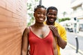 Young afircan american couple smiling happy and hugging at the city