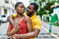 Young afircan american couple smiling happy and hugging at the city