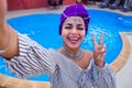 Young africa woman photographing mobile camera blogger summer vacation holiday against the backdrop of the swimming pool