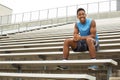 Teenage athlete sitting on the bleachers.