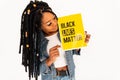 Young african american activist woman went out to support blacks in USA. Black girl holds a yellow poster