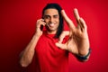 Young african american afro man with dreadlocks having conversation talking on smartphone doing ok sign with fingers, excellent Royalty Free Stock Photo