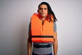 Young african american afro man with dreadlocks wearing orange lifejacket with serious expression on face Royalty Free Stock Photo