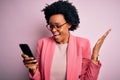 Young African American afro woman with curly hair having conversation using smartphone very happy and excited, winner expression Royalty Free Stock Photo