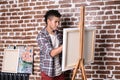 Young African-American artist painting picture in workshop Royalty Free Stock Photo