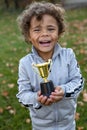 Young African American Athlete proudly holding a trophy. Royalty Free Stock Photo