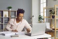 Young business man working on a laptop at office and looking on a computer screen. Royalty Free Stock Photo