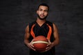 Young African-American basketball player in sportswear isolated over dark background. Royalty Free Stock Photo