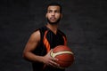 Young African-American basketball player in sportswear isolated over dark background. Royalty Free Stock Photo