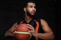 Young African-American basketball player in sportswear isolated over dark background. Royalty Free Stock Photo