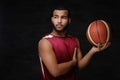 Young African-American basketball player in sportswear isolated over dark background. Royalty Free Stock Photo