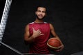 Young African-American basketball player in sportswear isolated over dark background. Royalty Free Stock Photo