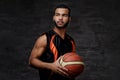 Young African-American basketball player in sportswear isolated over dark background. Royalty Free Stock Photo