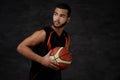 Young African-American basketball player in sportswear isolated over dark background. Royalty Free Stock Photo