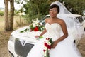 Young african american black bride posing with white limousine car in wedding day Royalty Free Stock Photo