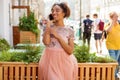Young African American black woman in pink dress talking on cellphone Royalty Free Stock Photo