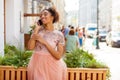 Young African American black woman in pink dress talking on cellphone Royalty Free Stock Photo