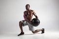Young african-american bodybuilder training over grey background Royalty Free Stock Photo