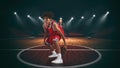 Young African American boy with basketball in the middle of the stadium Royalty Free Stock Photo
