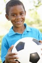 Young African American Boy Holding Football In Park Royalty Free Stock Photo