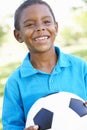 Young African American Boy Holding Football In Park Royalty Free Stock Photo