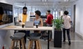 Young african american business advisors working together while standing with laptop at workplace