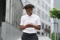 Young african american business lady in casual wear checking work emails outdoors. Royalty Free Stock Photo