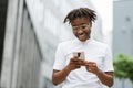 Young african american business lady in casual wear checking work emails outdoors. Royalty Free Stock Photo