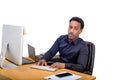 Young African American business man sitting at his office desk and typing on computer Royalty Free Stock Photo